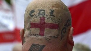 Tattoos are seen on the back of the head of a supporter of the English Defence League during a rally outside Downing Street in London