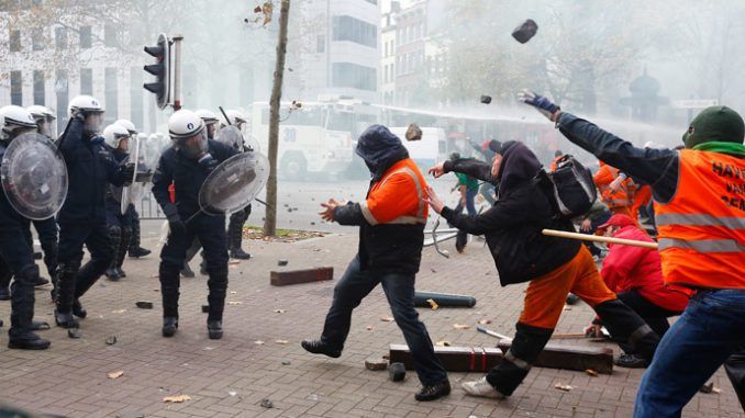 Police deploy water cannon and tear gas as 100,000 march in Brussels against austerity