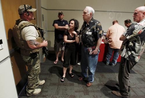 A police officer prevents attendees from leaving the Muhammad Art Exhibit and Contest after shots were fired outside the venue in Garland, Texas May 3, 2015.