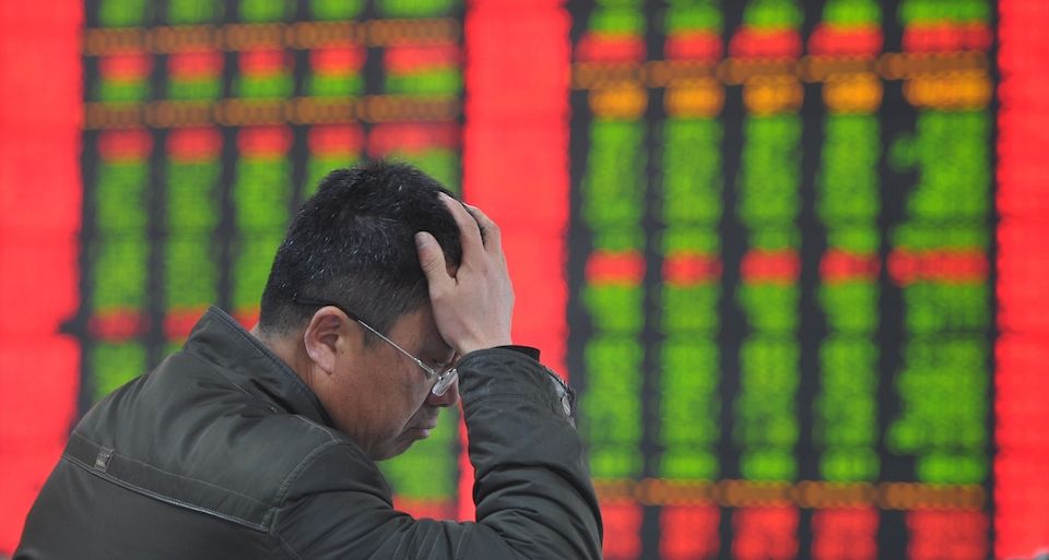 A stock investor gestures as he checks share prices at a securities firm in Fuyang, east China's Anhui province on January 19, 2015. Chinese shares plunged on January 19 after regulators punished several brokerages for violating rules for margin trading business, which has fuelled an extended market rally, analysts said.  AFP PHOTO    CHINA OUT        (Photo credit should read STR/AFP/Getty Images)