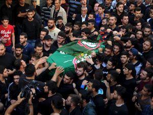 Mourners carry the coffin of the Shia Amal Movement party’s Hussein Hojeij, who died in the blast