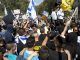 Israeli right wing protesters wave flags outside of Castina military court