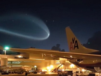 Airports workers in Miami were left stunned when a giant UFO floated above them, lighting up the night sky.