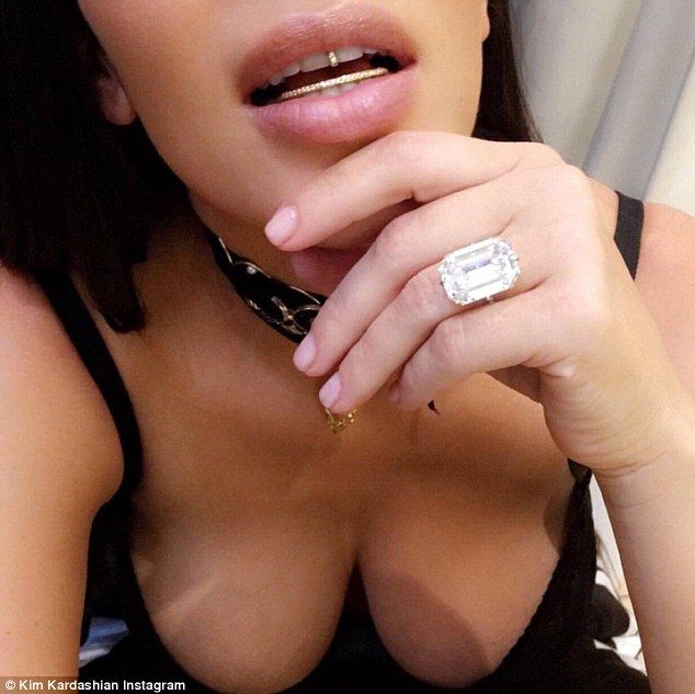 Kim showed off her weighty engagement ring and a diamond-encrusted grill on Instagram just hours before the robbery. 
