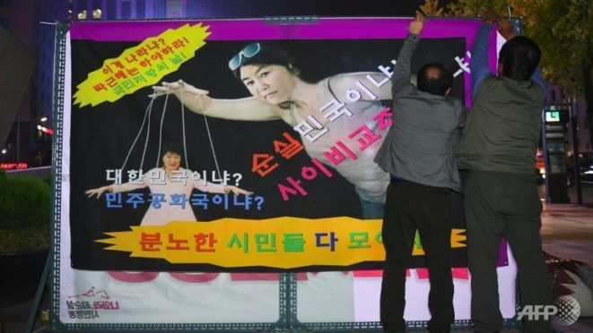 Posters of the president being controlled by puppet strings are cropping up all over South Korea as country-wide protests continue to rage.