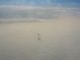Airplane passenger captures weird humanoid creature walking across a cloud