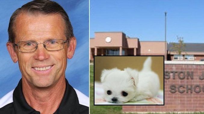 A science teacher in Idaho is under investigation after he was caught feeding a live puppy to one of his pet reptiles in front of students.