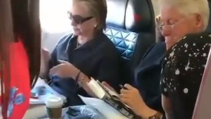 Clintons caught flying commercial, reading book about child rape