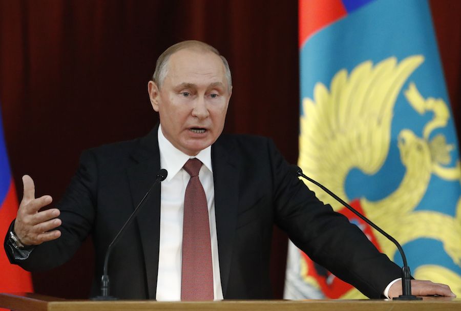 Vladimir Putin warns dark forces are conspiring to bring down President Trump