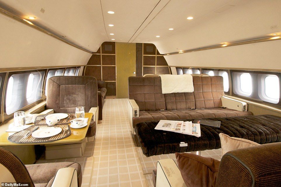 The luxury aircraft built in 1969 has been modernized and boasts plush furnishing and recessed lighting in these exclusive shots. Our photos also show a circular shaped lounge filled with beige comfy chairs (pictured) 