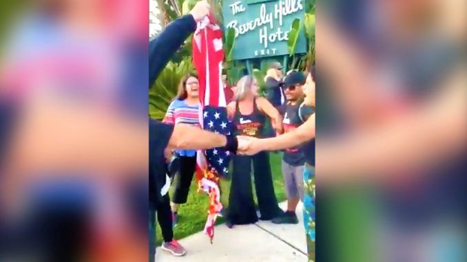 Anti-Trump protestors burned an American flag amid the arrival of President Donald Trump in Los Angeles for a fundraising event.