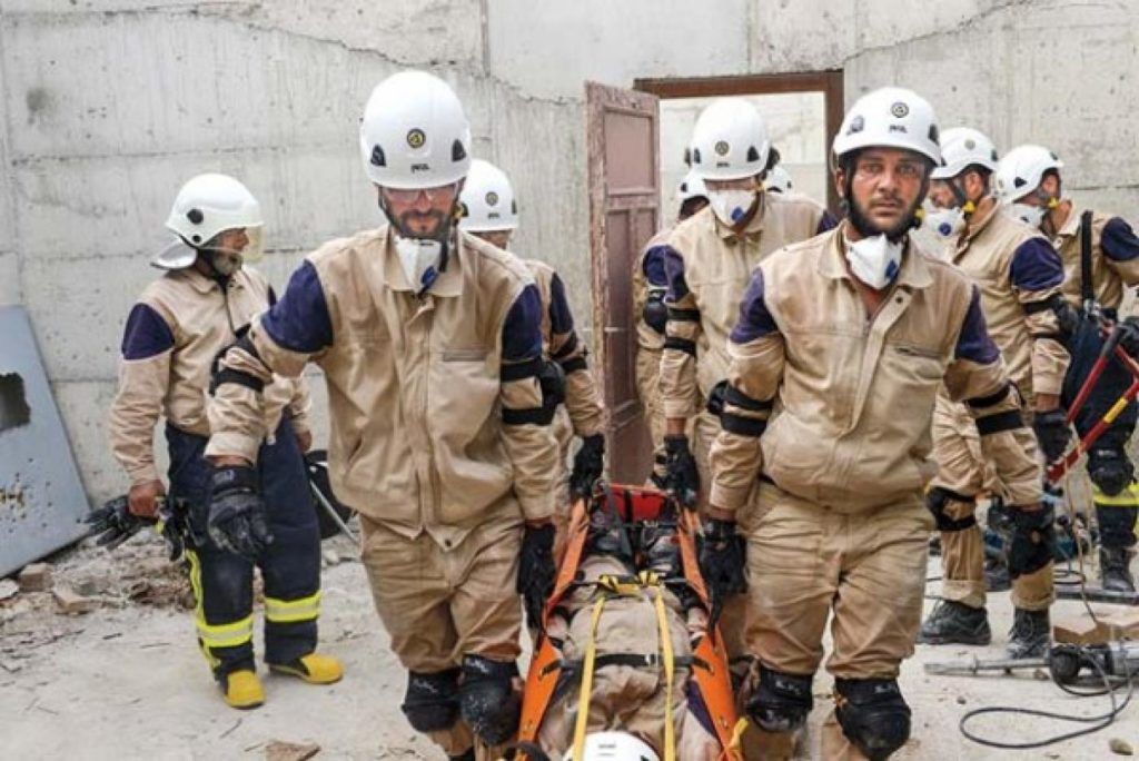 This original report, if it had been published as written, would not have supported widespread claims that poison gas was used at Douma on April 7, 2018. If any such gas was used, it was not a gas known to, or detected by the scientists who visited the scene, examined the buildings and soil and carefully checked the samples. (Above, White Helmets members in action at the site of the supposed gas attack.)