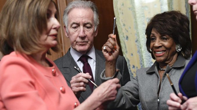 Nancy Pelosi uses over a dozen commemorative pens to sign articles of impeachment before handing them out like prizes to fellow Democrats