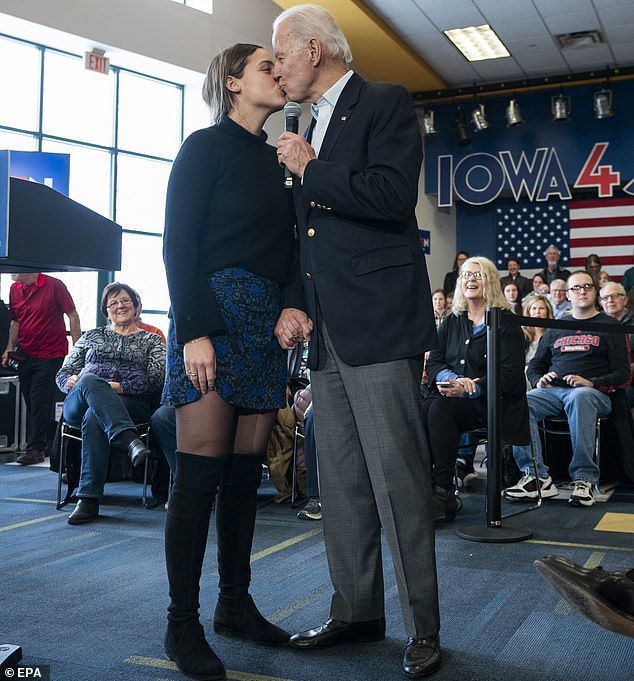 What the... ? Joe Biden gave his 19-year-old granddaughter Finnegan Biden a kiss on the lips while giving a speech at a campaign trail event in Dubuque, Iowa on Sunday