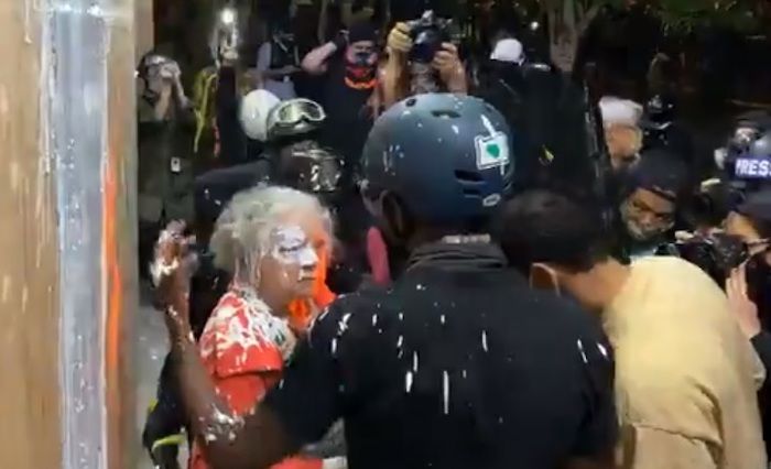 Violent Antifa rioters in Portland attacked an elderly woman who was using a walker after she attempted to stop the rioters burning down the East Precinct building of the Portland Police Department.