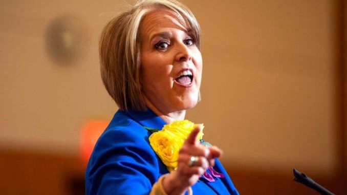 New Mexico's Dem Governor says protests are ok but knocking on doors to register voters is not