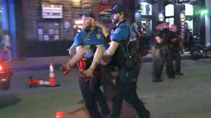 One of two suspects has been arrested over a mass shooting in downtown Austin that left 14 people injured during a night out in the Austin's entertainment district.