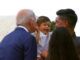 Baby cries out in terror as Joe Biden leans in for his signature sniff and kiss