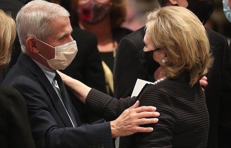 Dr. Anthony Fauci embraces Hillary Clinton at funeral
