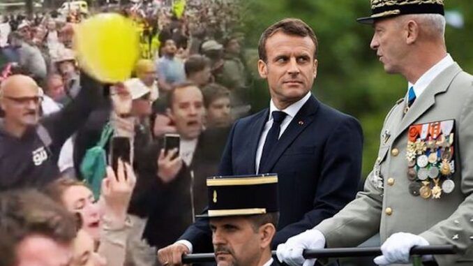 Macron trembles with fear as crowd loudly boo him at Bastille Parade in France