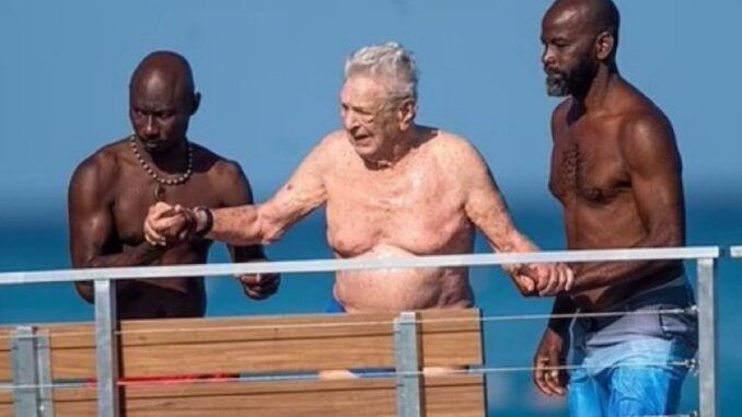 Recent photos published by the Daily Mail showed 93-year-old globalist George Soros taking a swim in Bridgetown, Barbados, with a muscular entourage of rent boys.