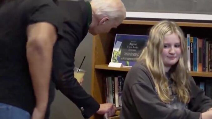 Underage girl recoils in horror as Biden gropes her and whispers something nasty in her ear.