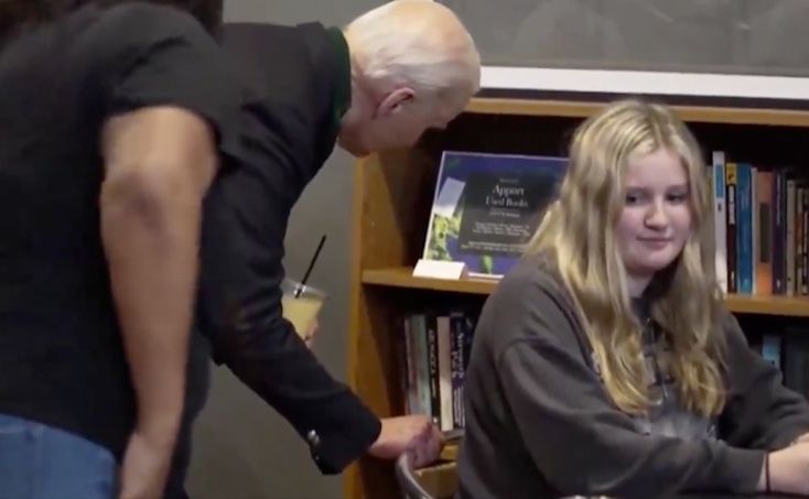 Underage girl recoils in horror as Biden gropes her and whispers something nasty in her ear.
