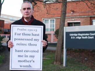 Pastor arrested for holding sign that disapproves of abortion