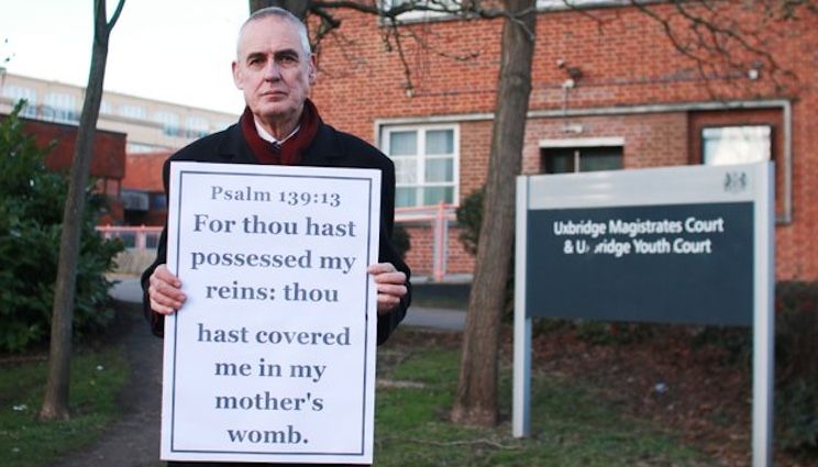 Pastor arrested for holding sign that disapproves of abortion
