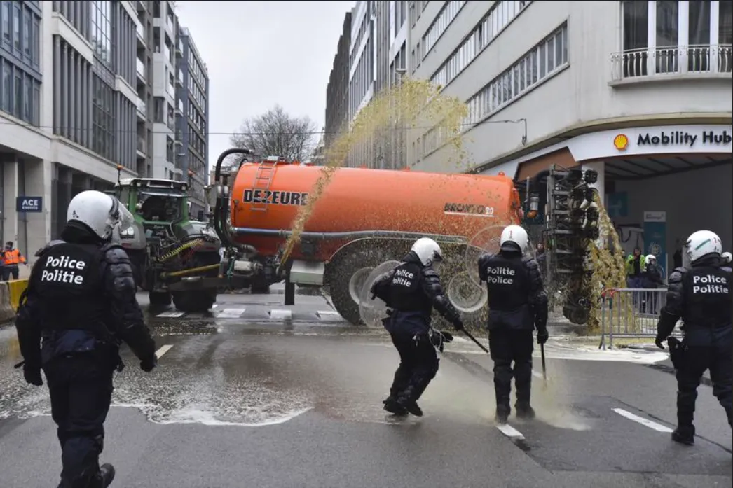 EU Police Protecting WEF Elites Sprayed With Liquid Manure By Protesting Farmers